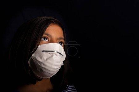 Photo for Portrait of little girl wearing a medical mask used for virus protection - Royalty Free Image