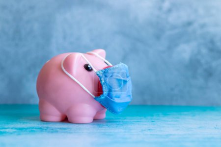 Photo for Pink piggy bank with medical mask - Royalty Free Image