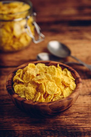 Photo for Corn flakes in a wooden bowl - Royalty Free Image