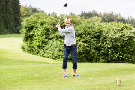 Photo for Male golf player taking a shot - Royalty Free Image