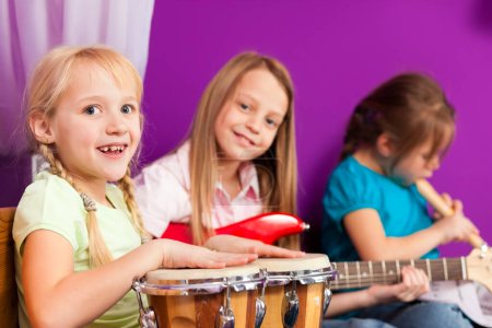 Photo for Happy children play and singing with instruments. - Royalty Free Image