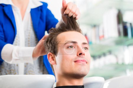 Photo for Hairdresser advice man on haircut in barbershop - Royalty Free Image