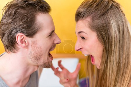 Photo for Young married couple, woman and man, in furious fight - Royalty Free Image