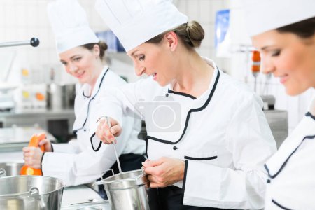 Photo for "Team of chefs in production process of system catering" - Royalty Free Image