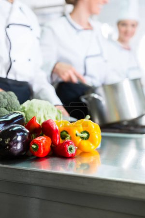 Photo for "chefs preparing meals in commercial kitchen" - Royalty Free Image