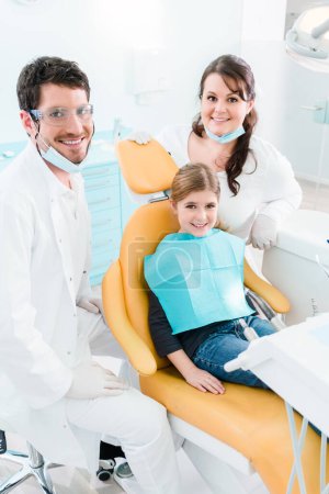Photo for "Dentist treating child in his surgery" - Royalty Free Image