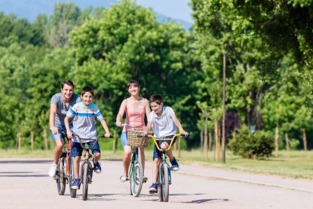 Photo for Family of four on bike tour in summer - Royalty Free Image