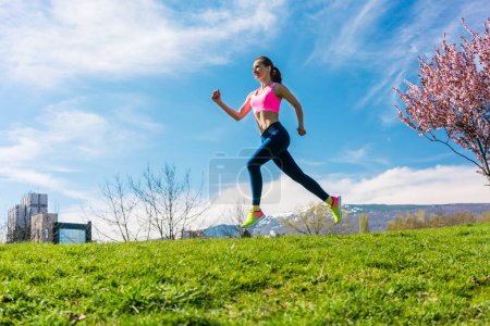 Photo for "Woman sport running on hill for fitness" - Royalty Free Image