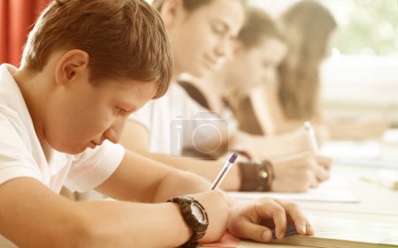 Photo for Students or pupils writing test in school being concentrated - Royalty Free Image