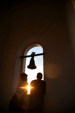 Photo for Catholic church bell and people - Royalty Free Image