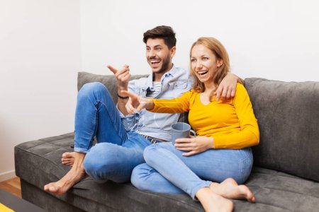 Photo for "couple in love watching tv" - Royalty Free Image