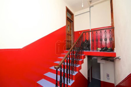 Photo for Red staircase in the building of an old house - Royalty Free Image