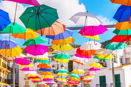 Photo for "Colourful umbrellas urban street decoration. Hanging colorful umbrellas over blue sky, tourist attraction" - Royalty Free Image