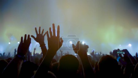 Foto de Concert Music festival and Celebrate. Party People Rock Concert. Crowd Happy and Joyful and Applauding or Clapping. Celebration party festival happiness. Blurry night club. Concert Show with DJ Music festival EDM on Stage - Imagen libre de derechos