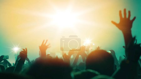 Foto de "Concert Music festival and Celebrate. Party People Rock Concert. Crowd Happy and Joyful and Applauding or Clapping. Celebration party festival happiness. Blurry night club. Concert Show with DJ Music festival EDM on Stage" - Imagen libre de derechos