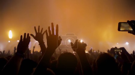 Photo for "Concert Music festival and Celebrate. Party People Rock Concert. Crowd Happy and Joyful and Applauding or Clapping. Celebration party festival happiness. Blurry night club. Concert Show with DJ Music festival EDM on Stage" - Royalty Free Image
