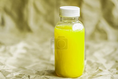 Photo for "Fresh lime or lemon juice in eco-friendly recyclable plastic bottle and packaging, healthy drink and food product" - Royalty Free Image