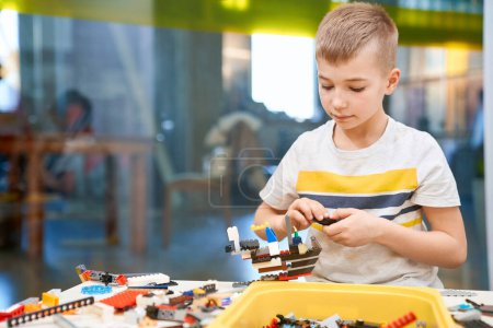 Photo for Caucasian boy using building kit - Royalty Free Image