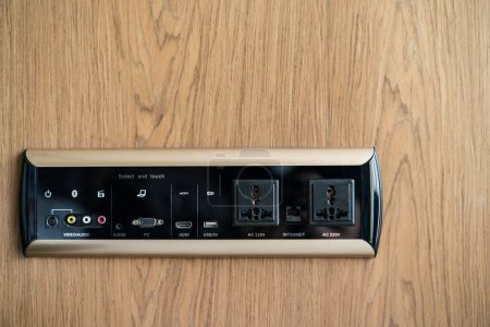 Photo for "Electrical wall socket adapter, plug power outlet and USB charger socket on the wooden wall." - Royalty Free Image