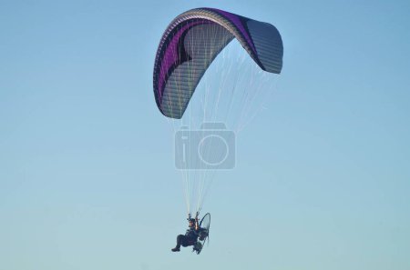 Photo for Man paragliging alone on sky background - Royalty Free Image