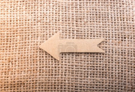 Photo for Arrow cut out of brown paper - Royalty Free Image