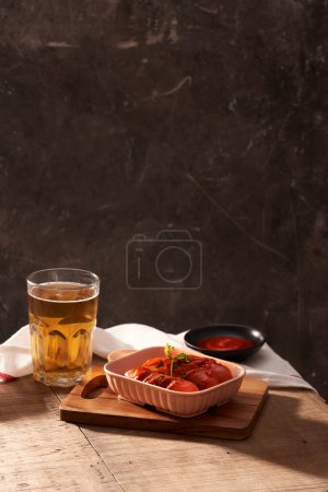 Photo for "Glass of delicious beer with grilled sausages on wooden table" - Royalty Free Image