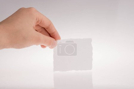 Photo for "Hand holding a piece of paper" - Royalty Free Image