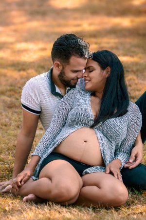 Photo for Couple expecting a child posing outdoors - Royalty Free Image