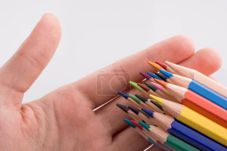 Photo for Hand holding colorful pencils - Royalty Free Image