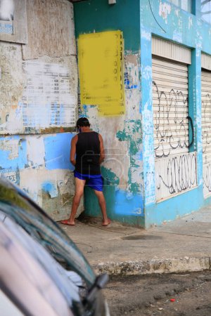 Photo for Person urinating in the street in salvador - Royalty Free Image