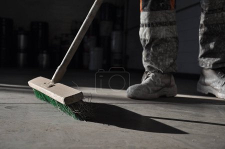 Photo for Cleaning of the production room using a brush. - Royalty Free Image