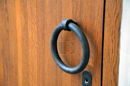 Photo for Heavy wooden doors brown. Ring shaped handle - Royalty Free Image