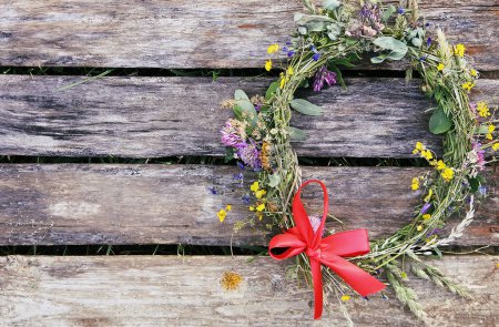 Photo for "Wreath of wildflowers on weathered wooden boards." - Royalty Free Image
