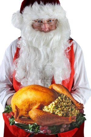 Téléchargez les photos : Père Noël servant un Thanksgiving rôti frais ou de Noël Turquie avec toutes les garnitures. - en image libre de droit