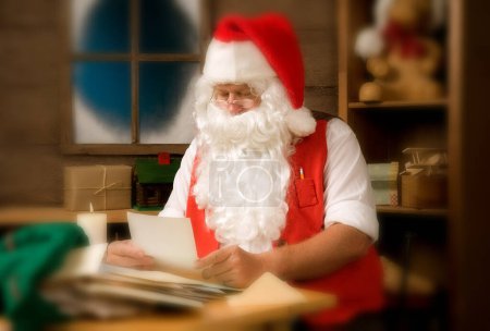 Photo for Santa Claus Reading Letters at home - Royalty Free Image