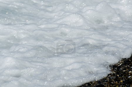Photo for "pebble beach washed by sea waves, small and various stones forming the shore" - Royalty Free Image