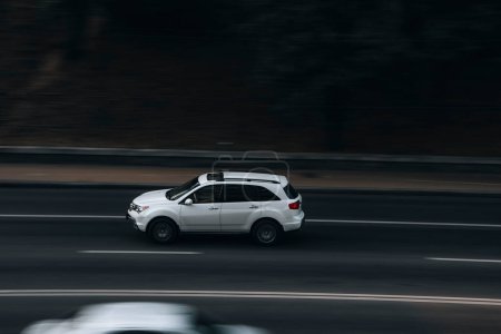 Photo for "Ukraine, Kyiv - 16 July 2021: White Acura MDX car moving on the street. Editorial" - Royalty Free Image