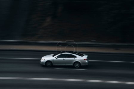 Photo for "Ukraine, Kyiv - 16 July 2021: White Lexus ES car moving on the street. Editorial" - Royalty Free Image