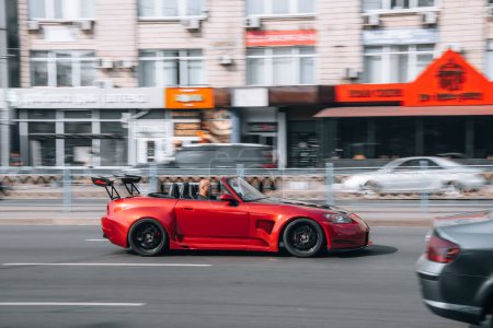 Photo for "Ukraine, Kyiv - 16 July 2021: Red Honda S2000 car moving on the street. Editorial" - Royalty Free Image