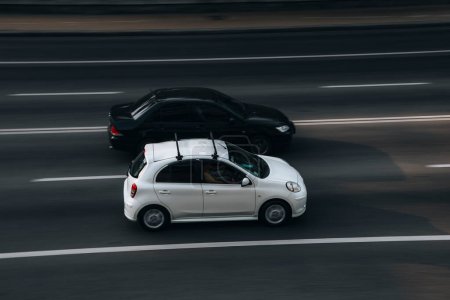 Photo for "Ukraine, Kyiv - 16 July 2021: White Nissan Micra car moving on the street. Editorial" - Royalty Free Image