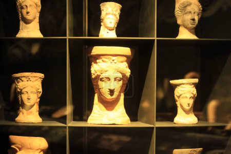 Photo for "Cauldrons shaped like terracotta female head" - Royalty Free Image