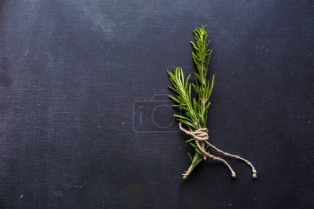 Photo for Close-up shot of fresh organic rosemary on tabletop for background - Royalty Free Image