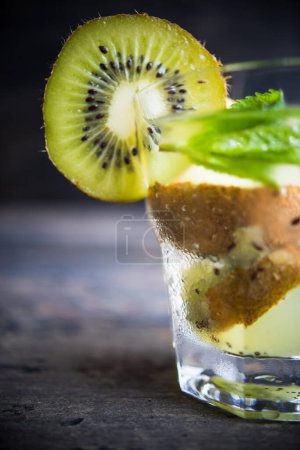 Photo for Close-up shot of fresh organic kiwi lemonade on tabletop for background - Royalty Free Image