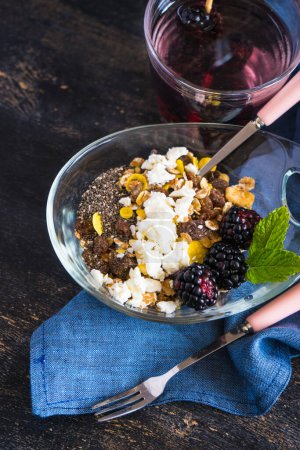 Photo for Close-up shot of fresh organic granola with blackberries on tabletop for background - Royalty Free Image