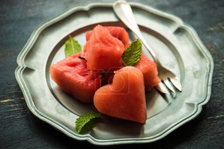 Photo for Close-up shot of fresh organic heart shaped watermelon on tabletop for background - Royalty Free Image