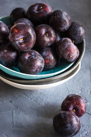 Photo for Close-up shot of fresh organic plums on tabletop for background - Royalty Free Image