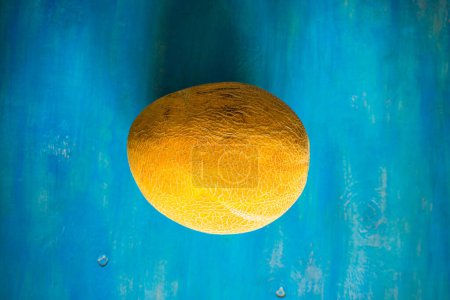 Photo for Close-up shot of fresh organic melon on tabletop for background - Royalty Free Image