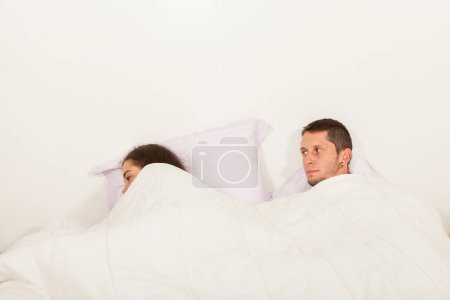 Photo for Young angry couple not talking to each other in bed with problems - Royalty Free Image