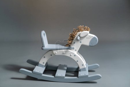 Photo for Handmade rocking horse on a gray background - Royalty Free Image