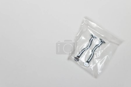 Photo for "Two metal curved fingers per package, machine repair parts." - Royalty Free Image